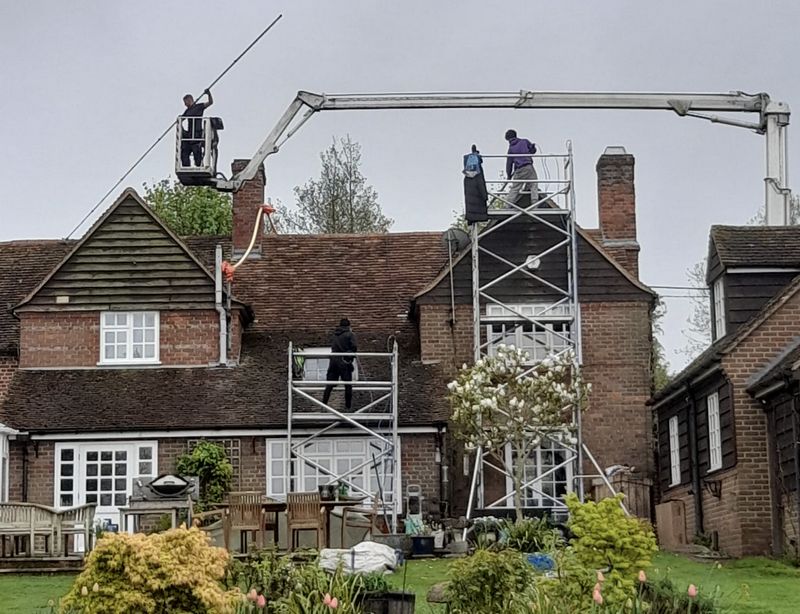 The Roof Moss Cleaners using cherry picker and scaffolding to clean roof safely and professionally in Henlow, Bedfordshire