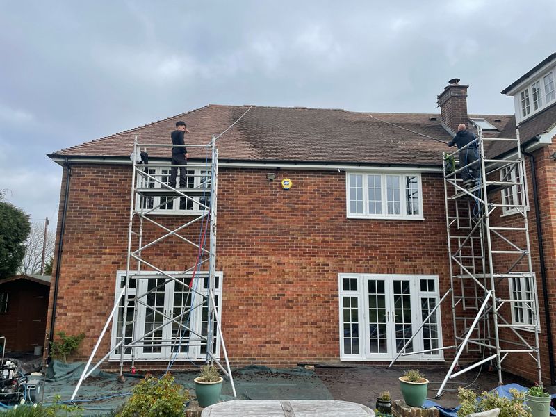 Roof cleaning carried out safely from scaffold towers by The Roof Moss Cleaners in Henlow